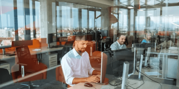 A man sitting at his desk working on a computer.