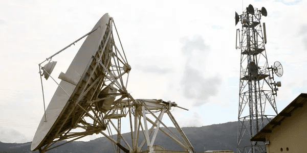 A large satellite dish sitting on top of a metal structure.